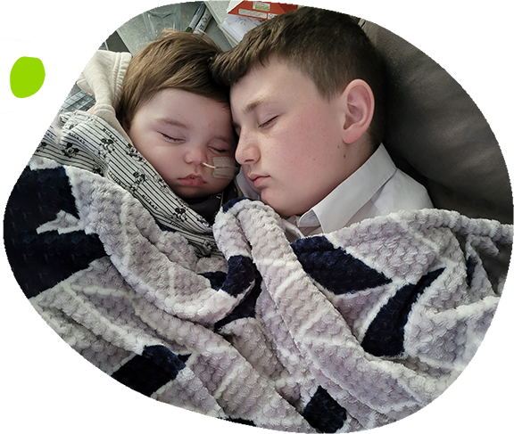 Brody & Declan cuddling under a blanket